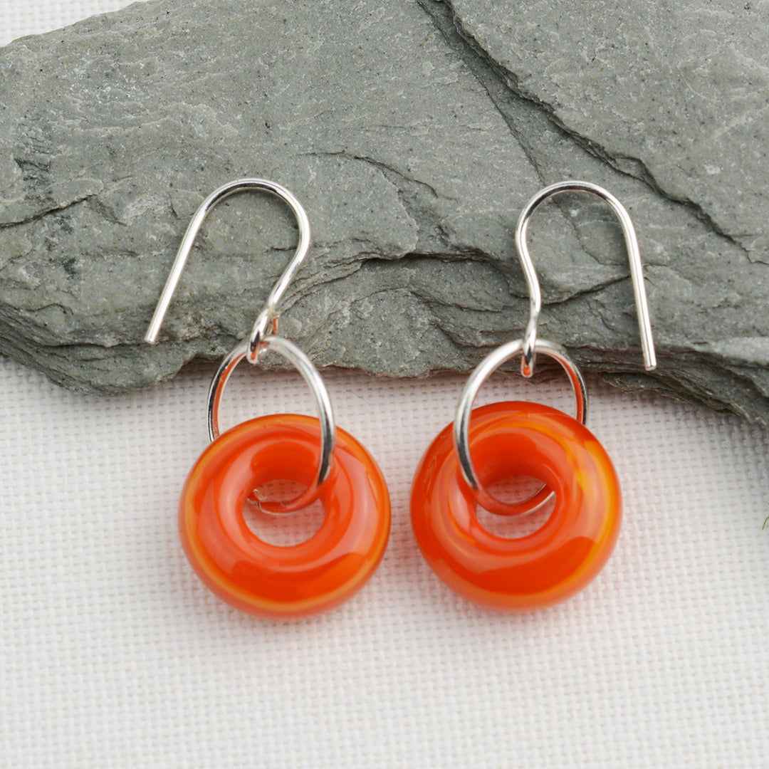 Doughnut shaped orange glass beads on silver drop earring hooks