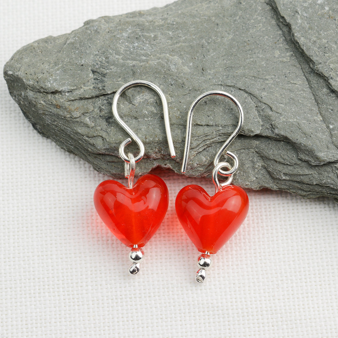 Heart shaped orange glass beads on silver drop earring hooks
