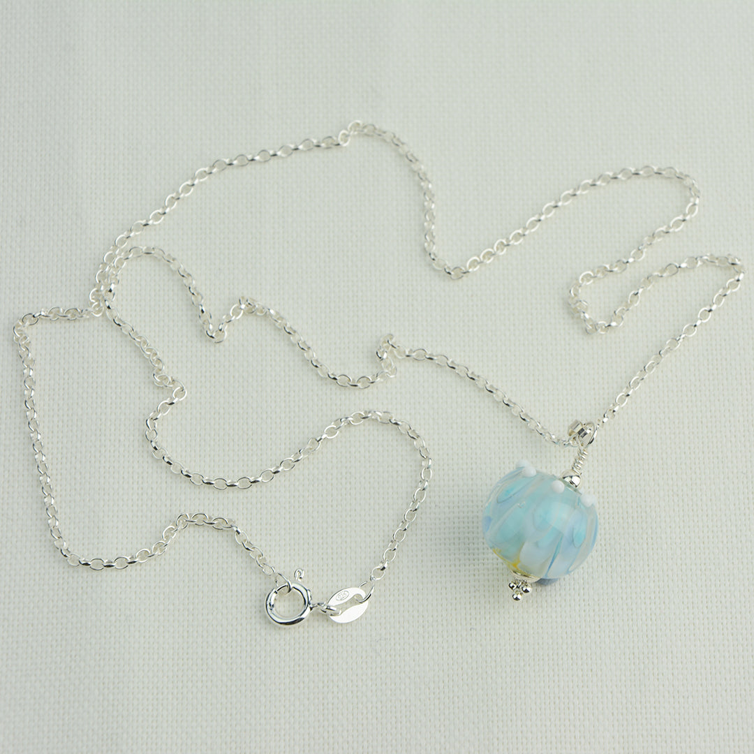 Pale blue and white glass beads imploded flower pendant on silver chain