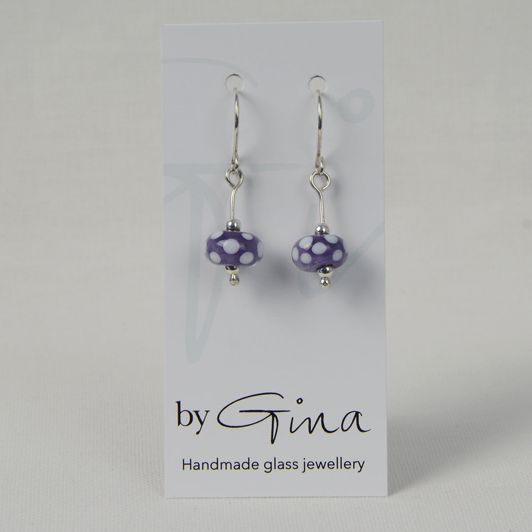 Encased purple with white spots glass bead earrings