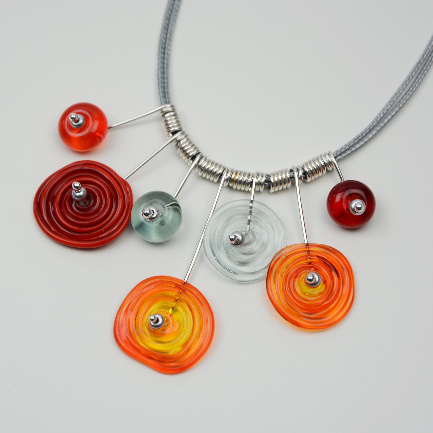 Spiral drop necklace in red, orange & grey, 7 bead