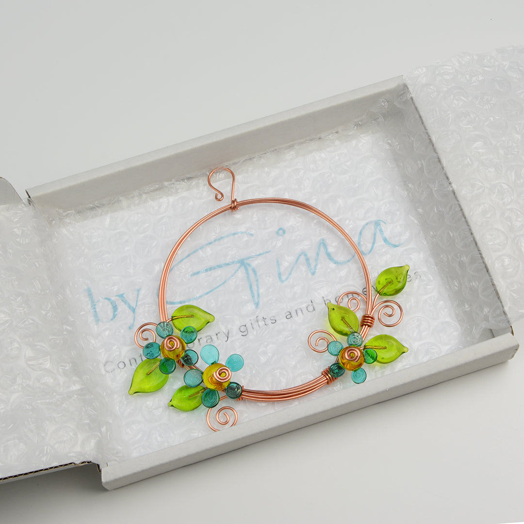 Miniature copper wreath with teal glass flowers and green glass leaves in white gift box