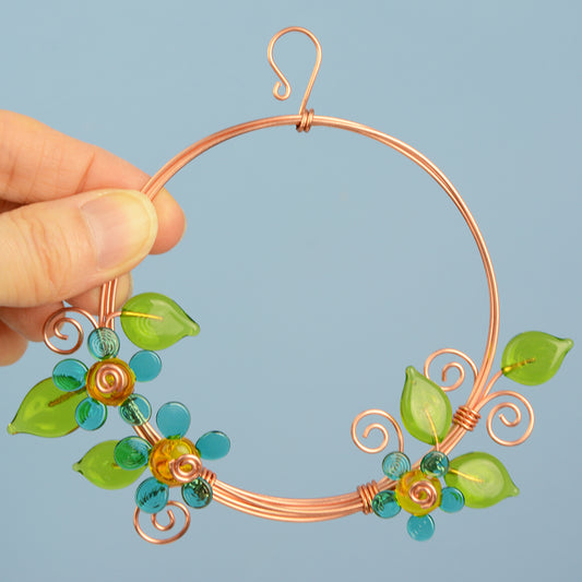 Miniature copper wreath with teal glass flowers and green glass leaves