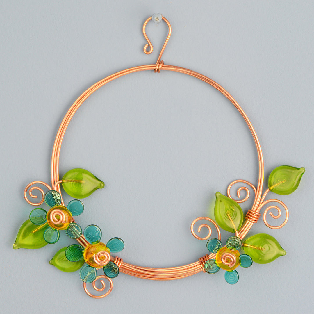 Miniature copper wreath with teal glass flowers and green glass leaves