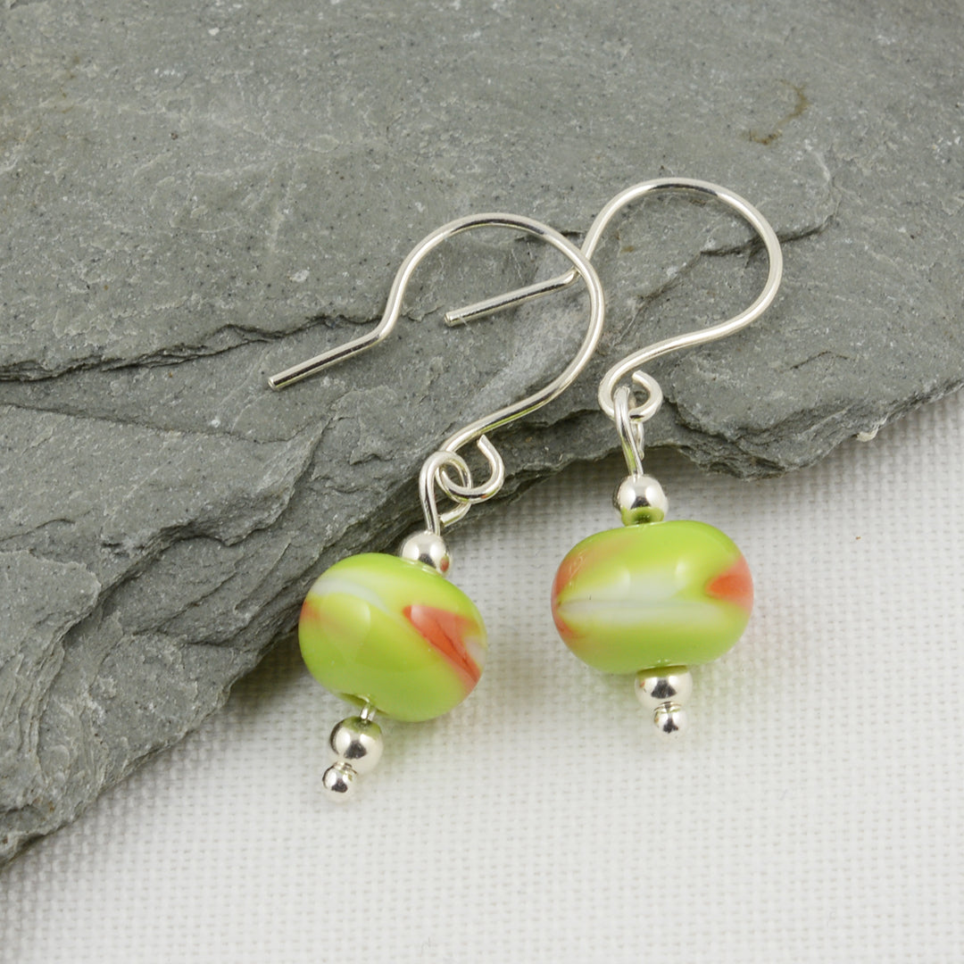Green, white and orange beads on silver drop earrings