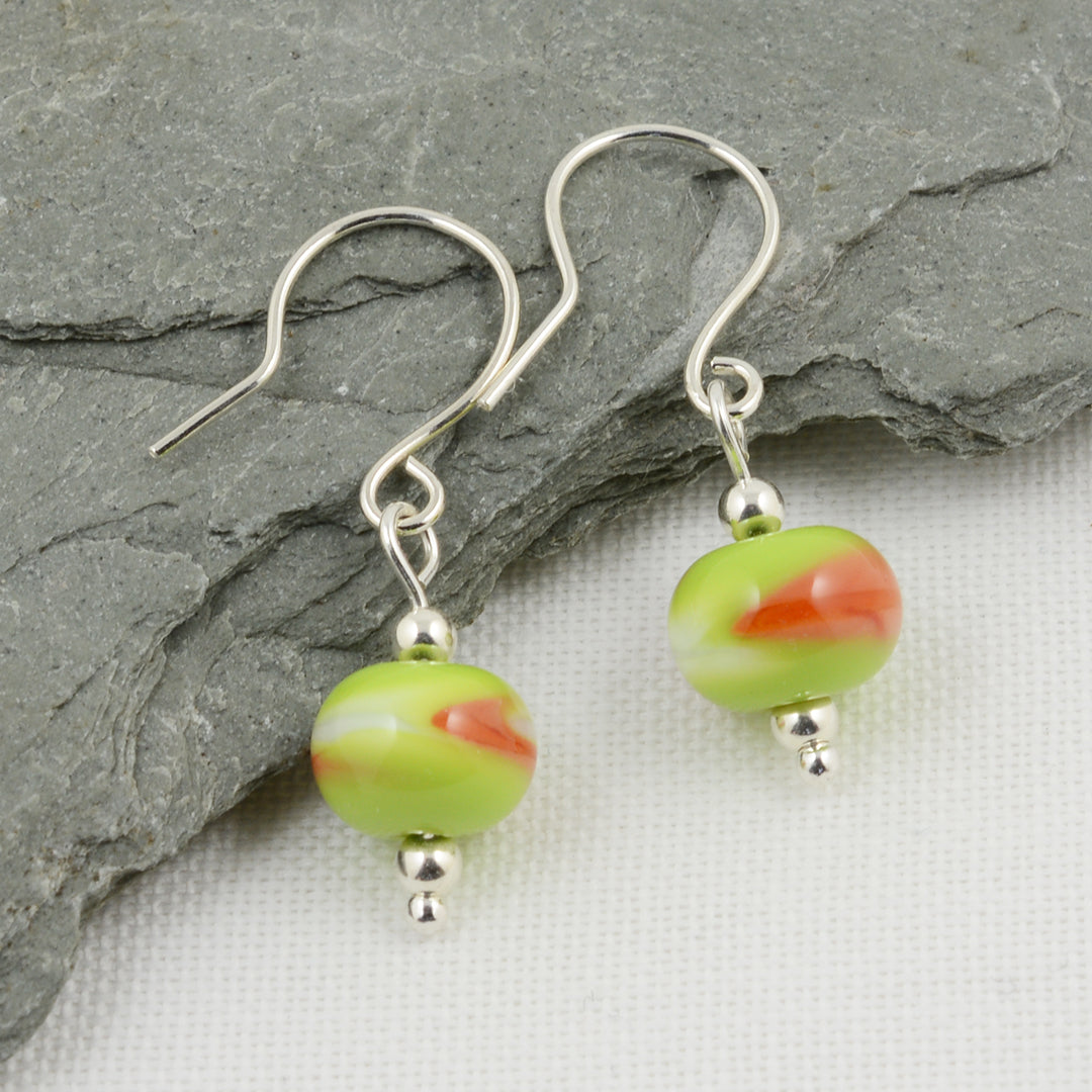 Green, white and orange beads on silver drop earrings