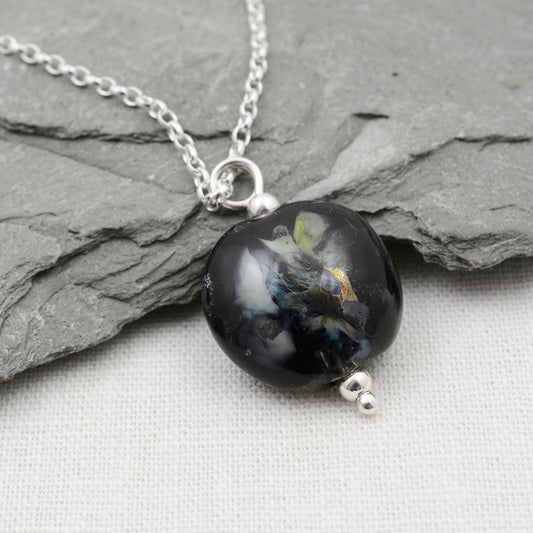 Black and silver lentil shaped glass bead pendant on silver chain