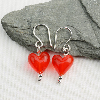 Heart shaped orange glass beads on silver drop earring hooks