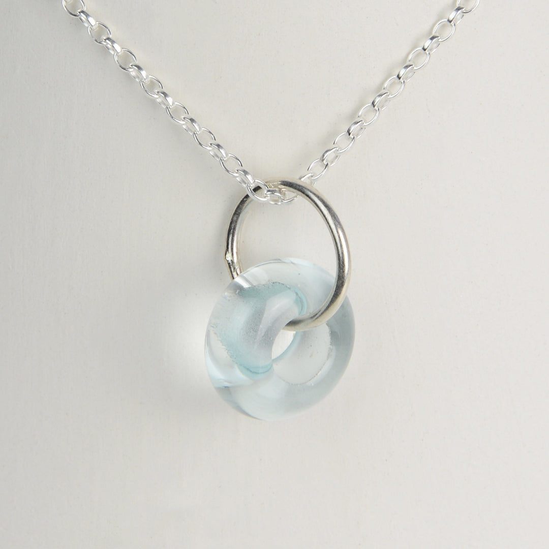 Doughnut shaped ice blue glass bead on silver chain