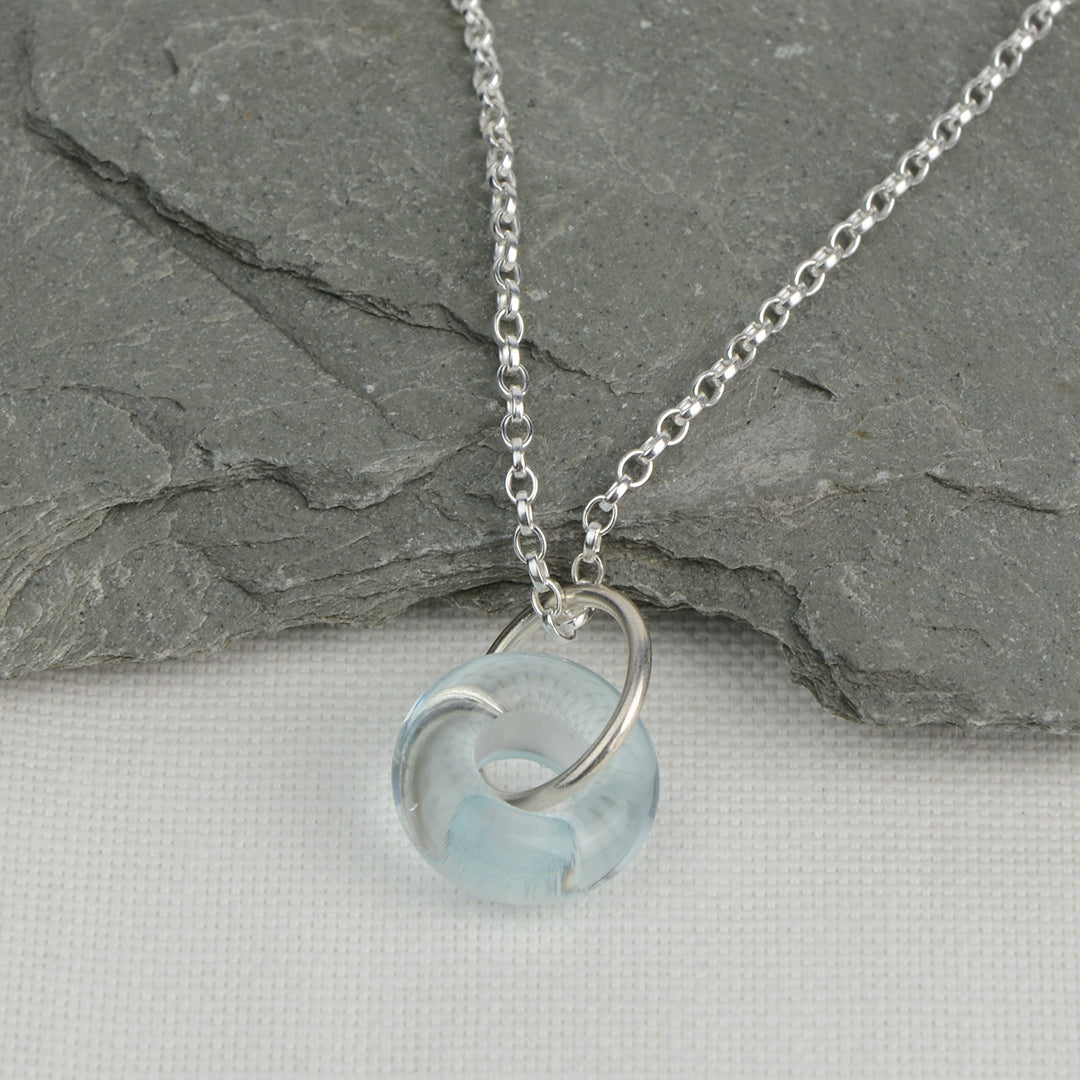 Doughnut shaped ice blue glass bead on silver chain