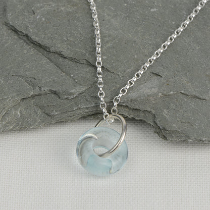 Doughnut shaped ice blue glass bead on silver chain