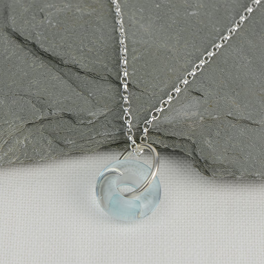Doughnut shaped ice blue glass bead on silver chain