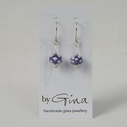 Encased purple with white spots glass bead earrings