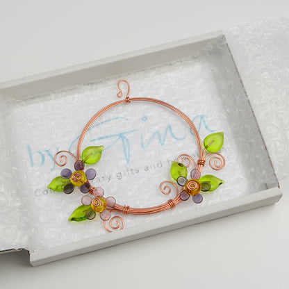 Miniature copper wreath with purple glass flowers and green glass leaves in white gift box