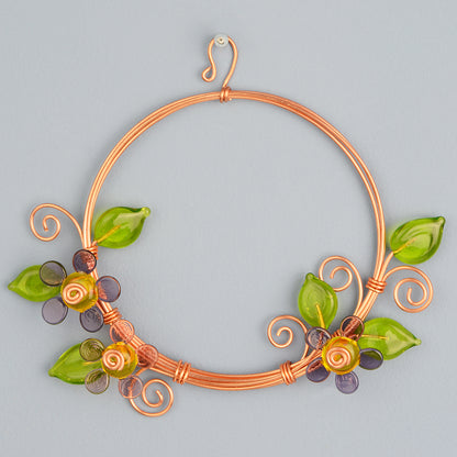 Miniature copper wreath with purple glass flowers and green glass leaves