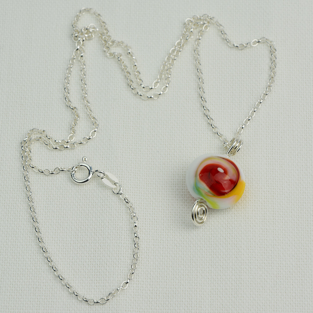 Multi coloured swirly lentil shaped glass bead pendant  on silver chain