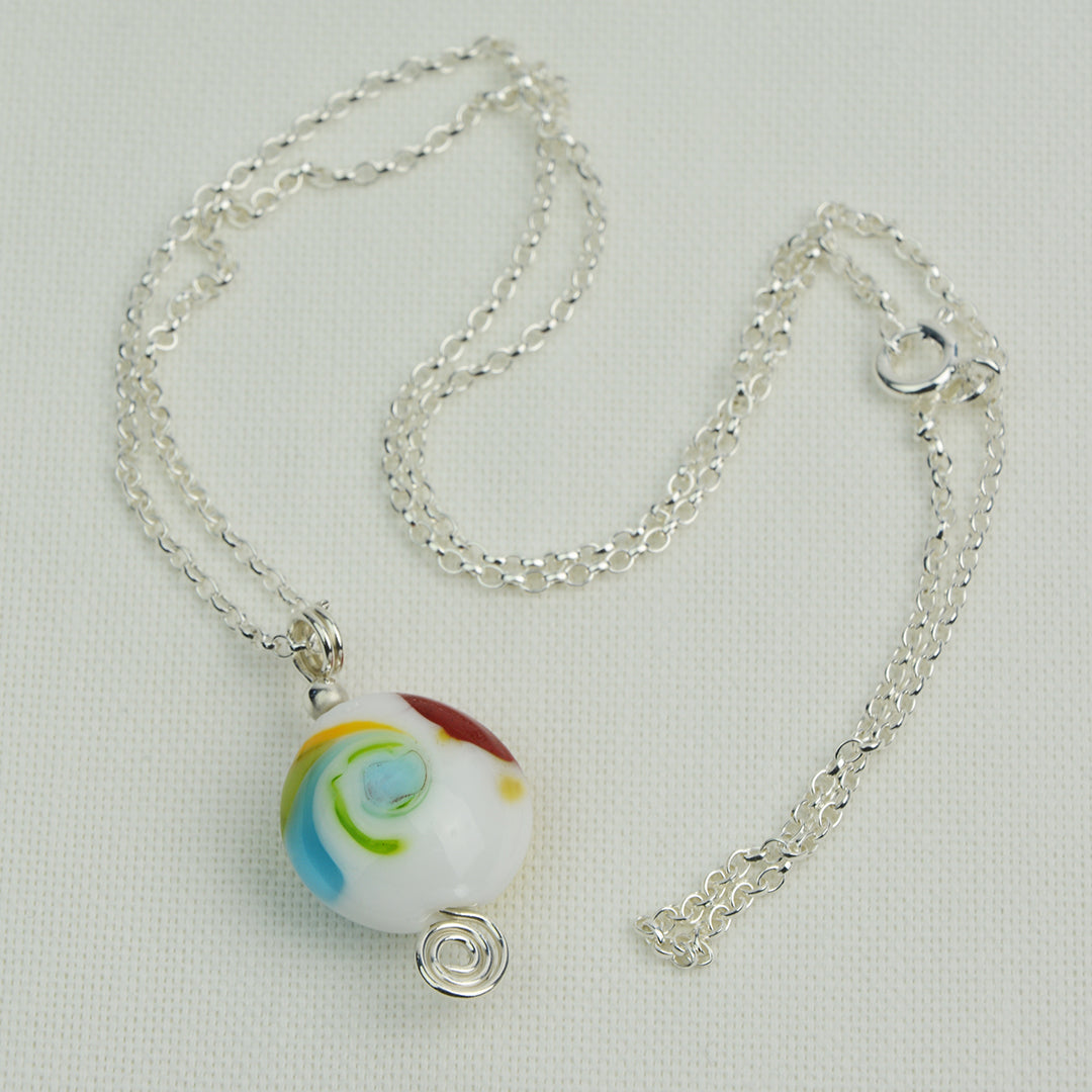 Multi coloured swirly lentil shaped glass bead pendant  on silver chain