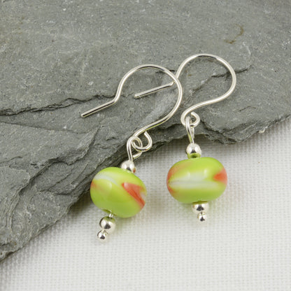 Green, white and orange beads on silver drop earrings