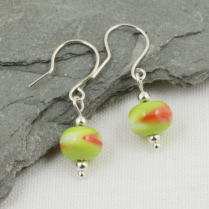 Green, white and orange beads on silver drop earrings