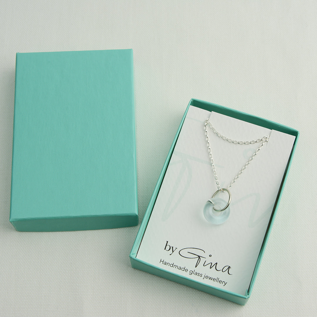 Doughnut shaped ice blue glass bead on silver chain in turquoise gift box