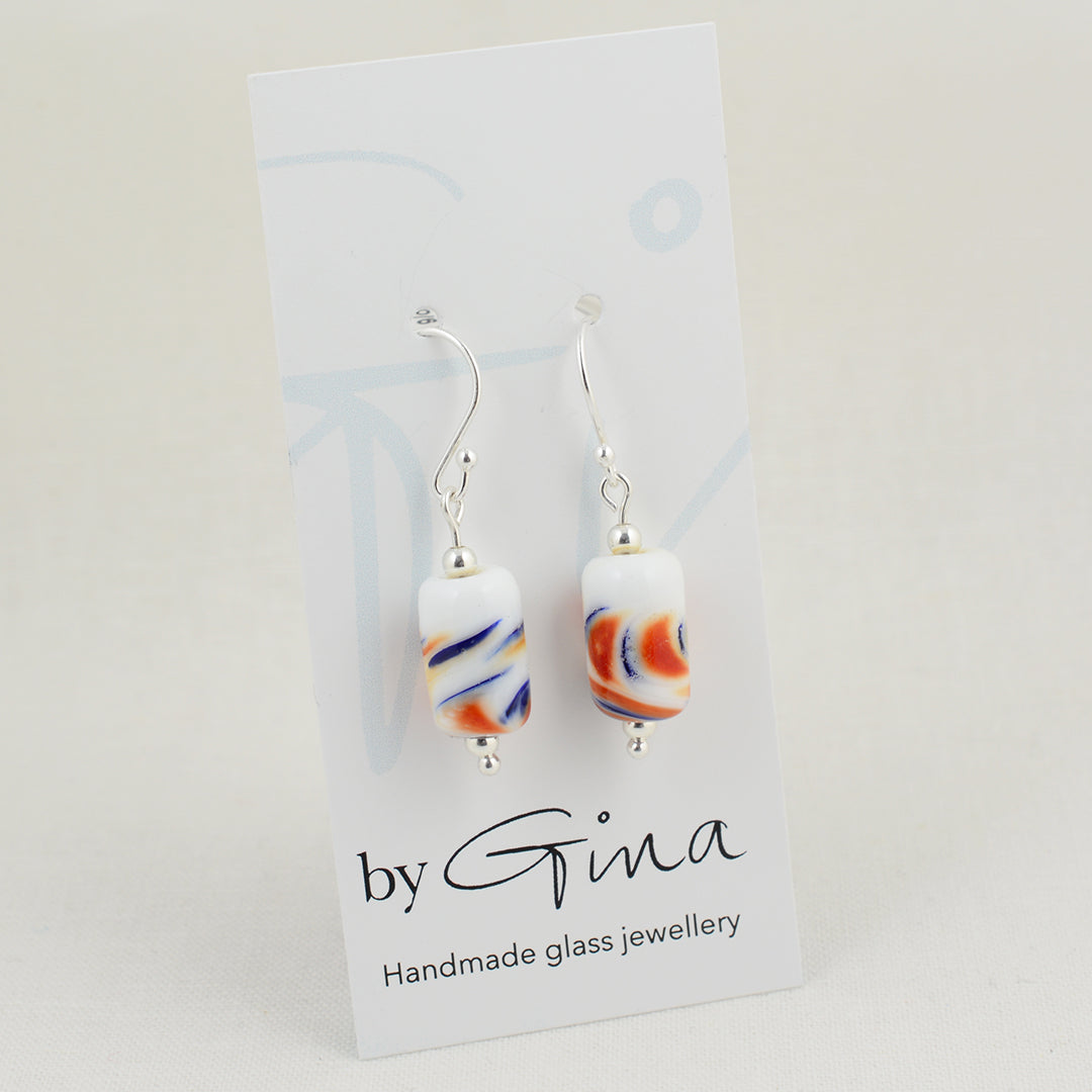 Long drop silver earrings with barrel shaped white glass beads with red and blue swirls