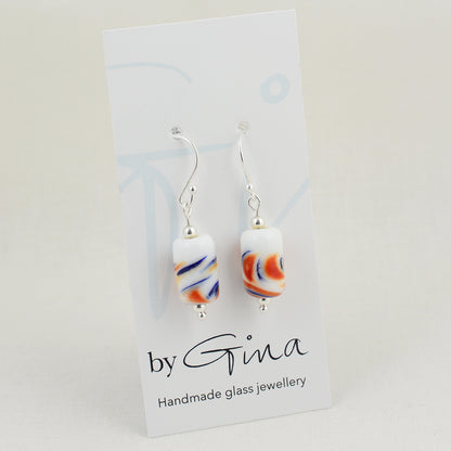Long drop silver earrings with barrel shaped white glass beads with red and blue swirls